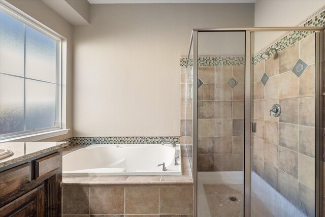 bathroom featuring vanity and plus walk in shower