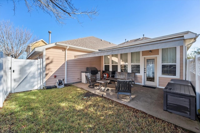 rear view of house with a lawn, a patio area, and an outdoor hangout area