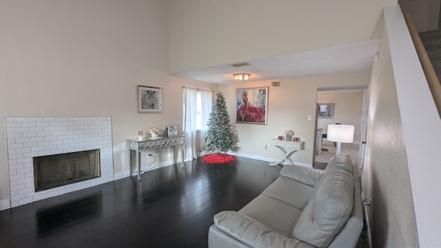 living room with hardwood / wood-style flooring and a fireplace