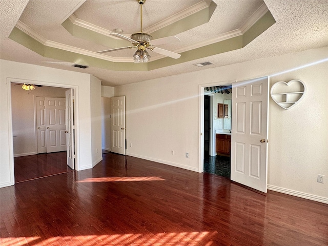 unfurnished bedroom featuring a raised ceiling and crown molding