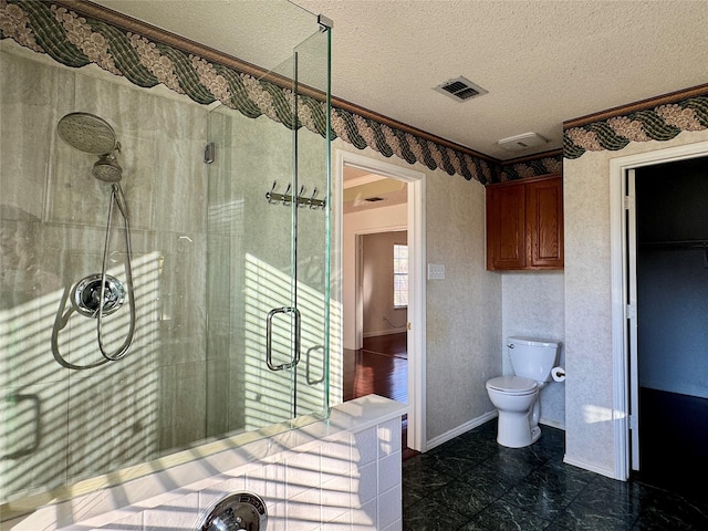 bathroom with toilet, a textured ceiling, and walk in shower