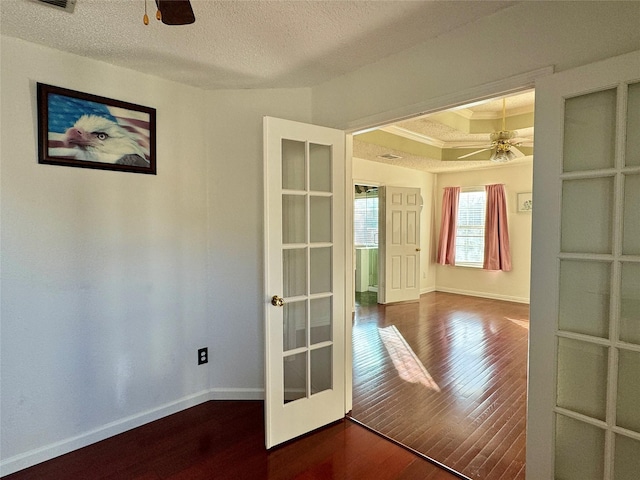 spare room with hardwood / wood-style floors, french doors, ceiling fan, and ornamental molding