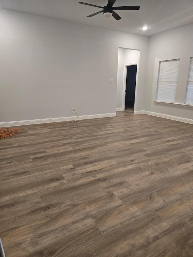 empty room featuring ceiling fan and dark hardwood / wood-style flooring