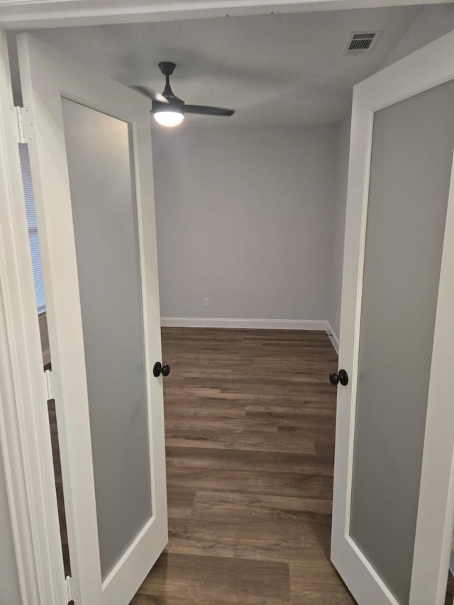 hallway with dark hardwood / wood-style flooring