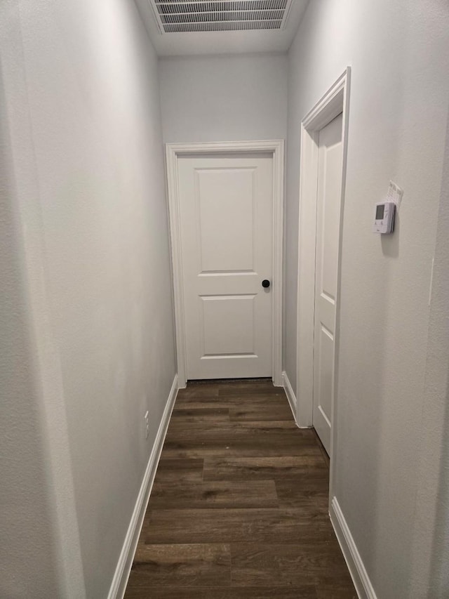 corridor featuring dark wood-type flooring