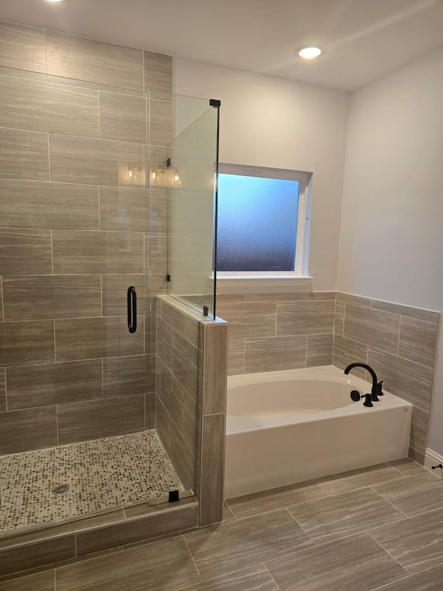 bathroom with shower with separate bathtub