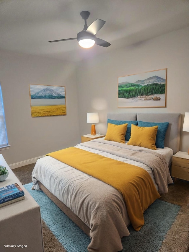 bedroom featuring ceiling fan and dark colored carpet