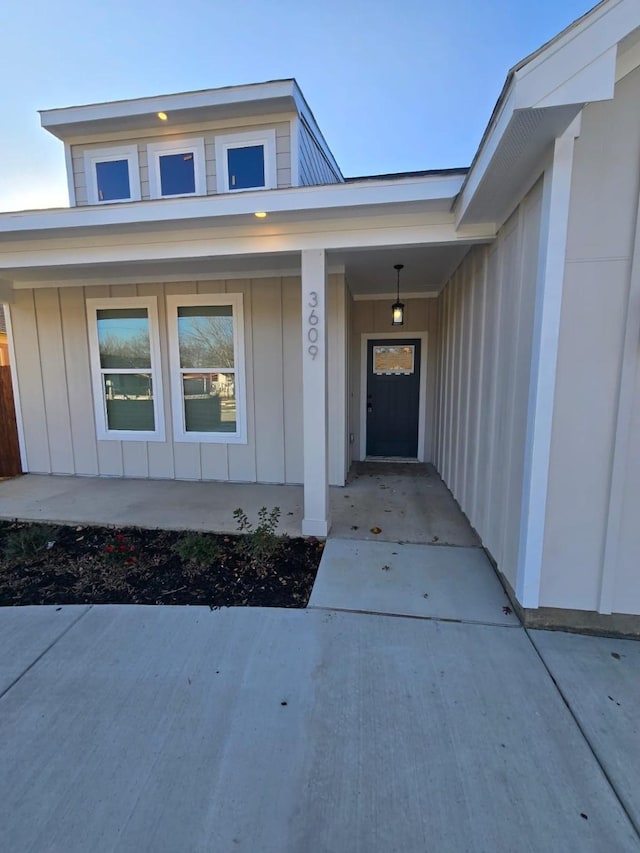 view of exterior entry with a porch