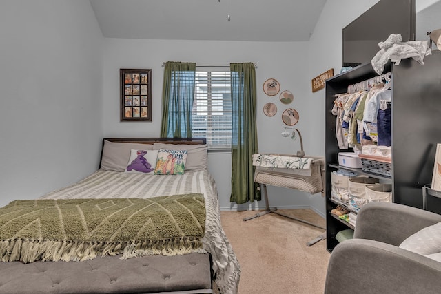 bedroom featuring carpet and baseboards