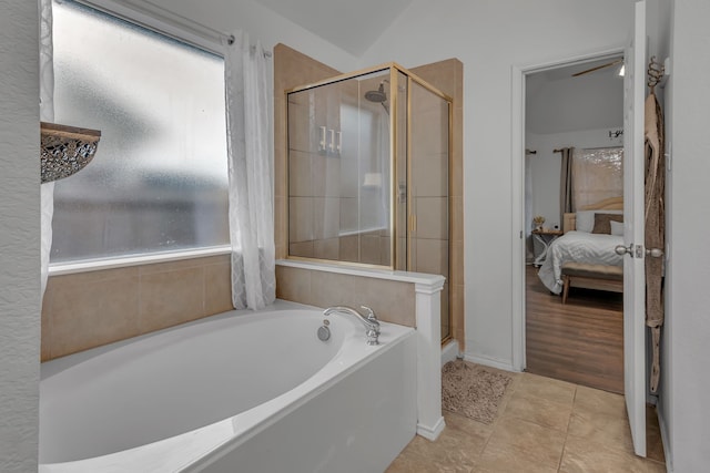 bathroom featuring tile patterned floors, connected bathroom, a bath, and a shower stall