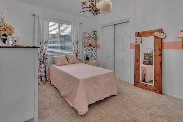 bedroom featuring a chandelier, carpet floors, and a closet