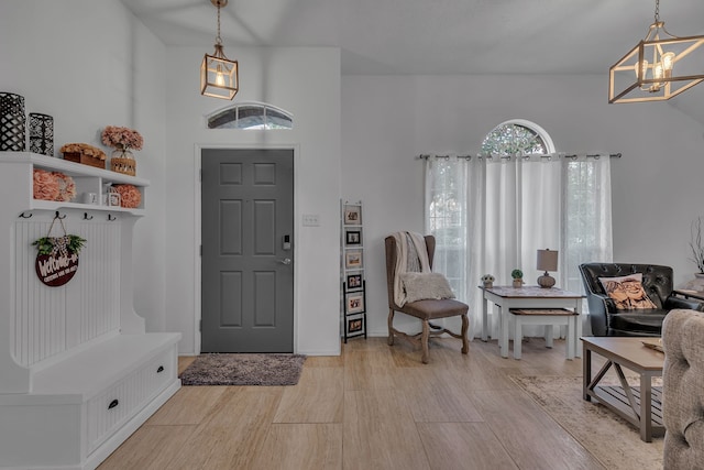 entrance foyer featuring light wood-style floors and a chandelier