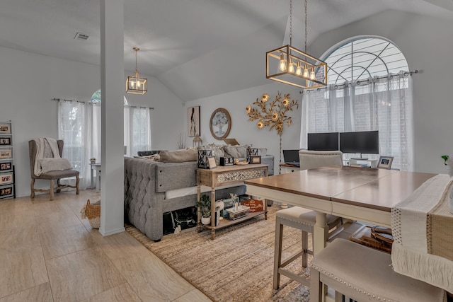 dining area featuring lofted ceiling and visible vents