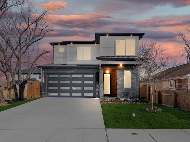 modern home with a yard and a garage