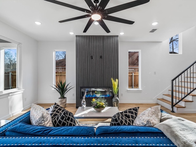 living room with ceiling fan and hardwood / wood-style floors