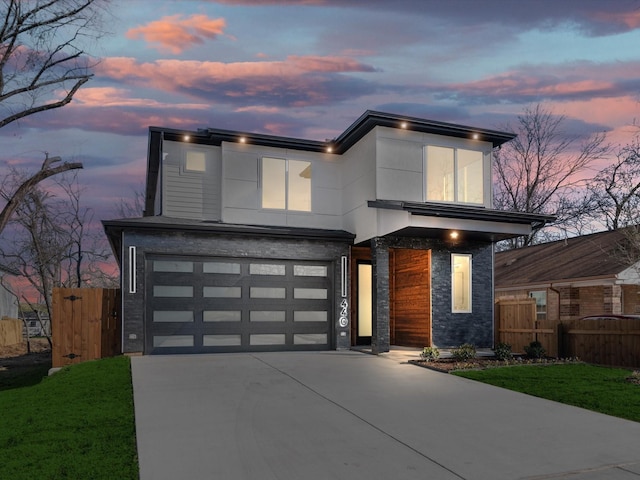 modern home with a garage and a yard