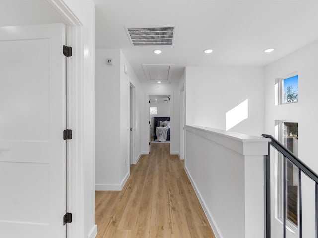 corridor with light hardwood / wood-style flooring