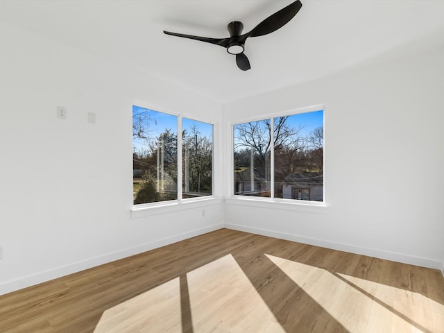 empty room featuring ceiling fan and hardwood / wood-style floors