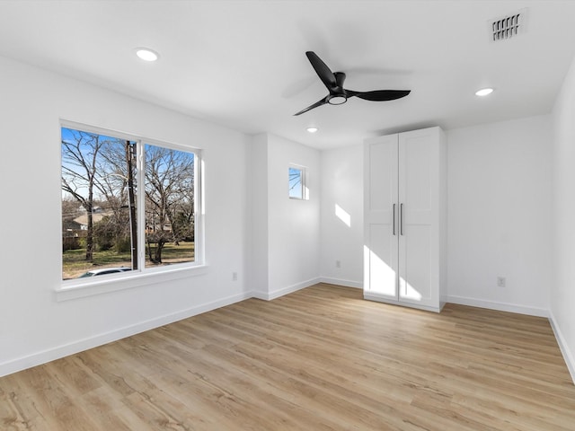 spare room with ceiling fan and light hardwood / wood-style floors