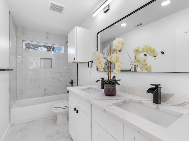 full bathroom featuring toilet, tiled shower / bath, and vanity