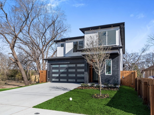 modern home featuring a front lawn and a garage