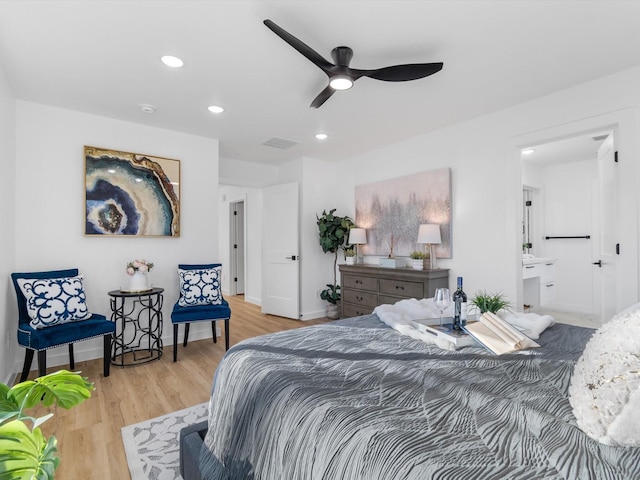 bedroom with ceiling fan, light hardwood / wood-style floors, and connected bathroom