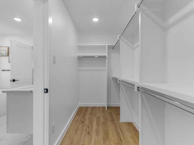 spacious closet featuring light hardwood / wood-style floors