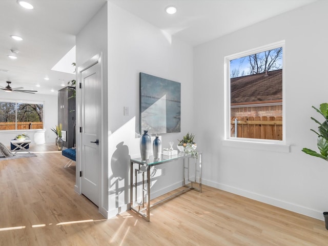 corridor with light hardwood / wood-style flooring