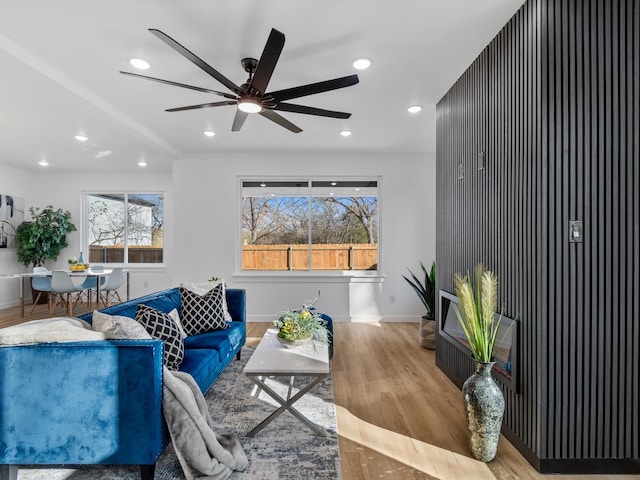 living room featuring ceiling fan and light hardwood / wood-style flooring