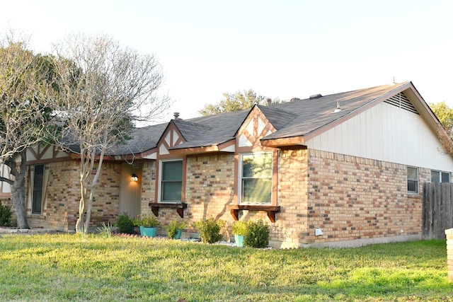 view of side of property with a lawn