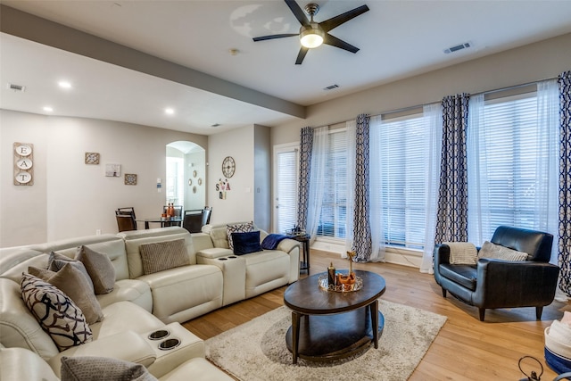 living room featuring a wealth of natural light, light hardwood / wood-style floors, and ceiling fan