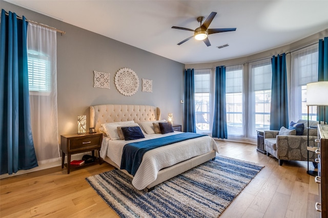 bedroom with ceiling fan and light hardwood / wood-style floors