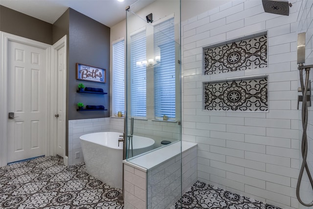 bathroom with tile patterned floors and shower with separate bathtub