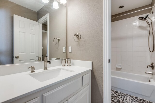 bathroom with vanity and tiled shower / bath combo