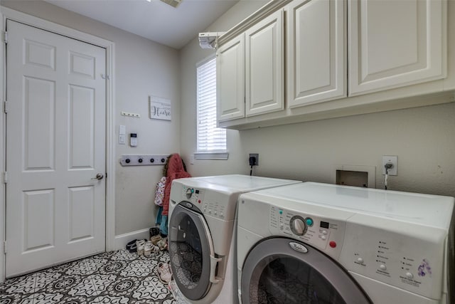 clothes washing area featuring cabinets, separate washer and dryer, and light tile patterned floors