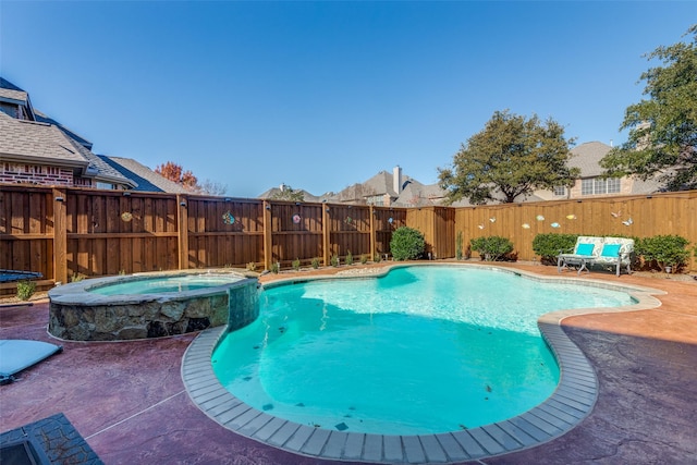 view of pool with an in ground hot tub and a patio area