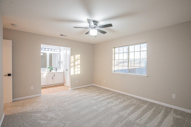 unfurnished room with ceiling fan and light colored carpet