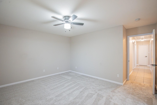 carpeted spare room with ceiling fan