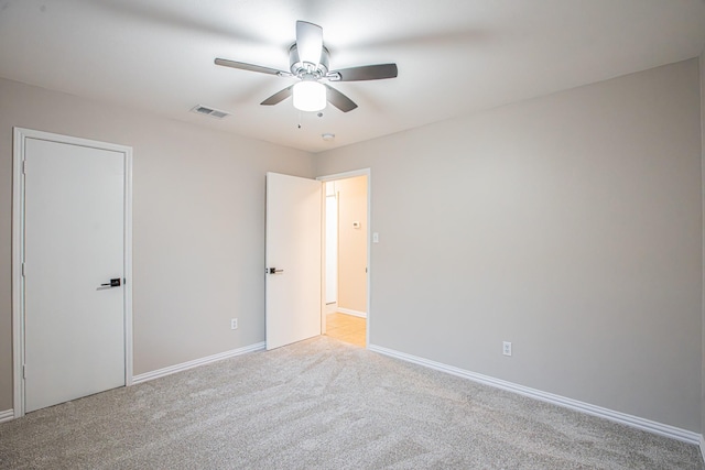 carpeted empty room with ceiling fan