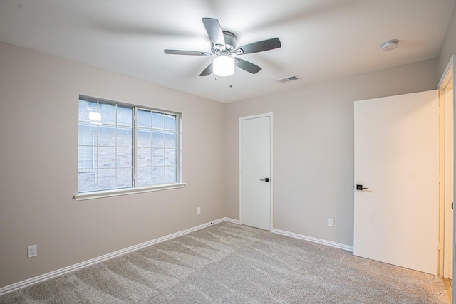 unfurnished bedroom featuring ceiling fan and light colored carpet