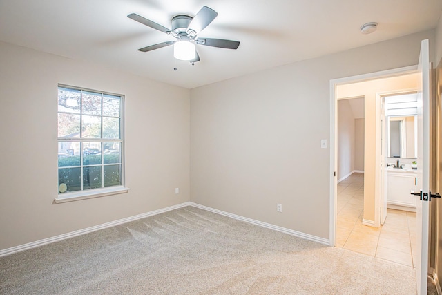 unfurnished room with ceiling fan and light colored carpet