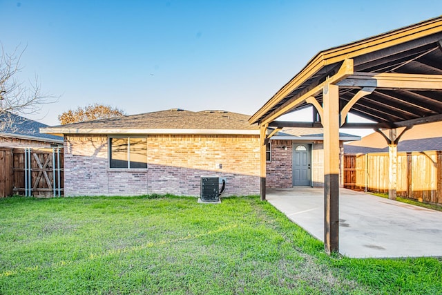 back of house with a yard, a patio, and central AC unit