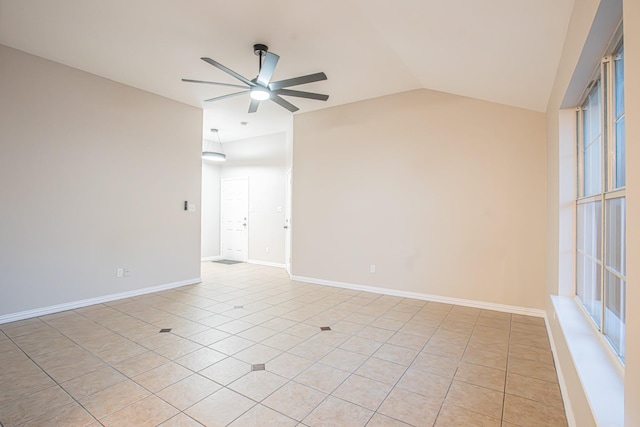 tiled empty room with ceiling fan and lofted ceiling