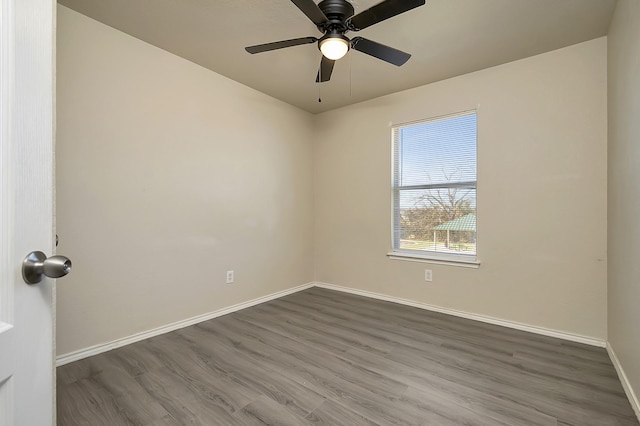 empty room with dark hardwood / wood-style floors and ceiling fan