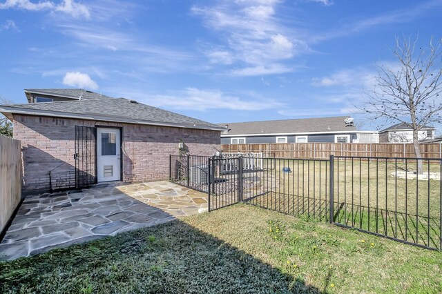 view of yard featuring a patio area and a fenced backyard