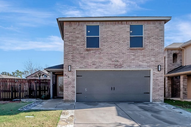 traditional-style house featuring a garage and concrete driveway