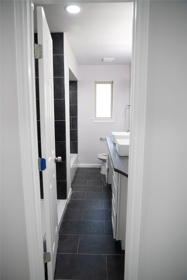 bathroom featuring tile patterned floors, vanity, and toilet