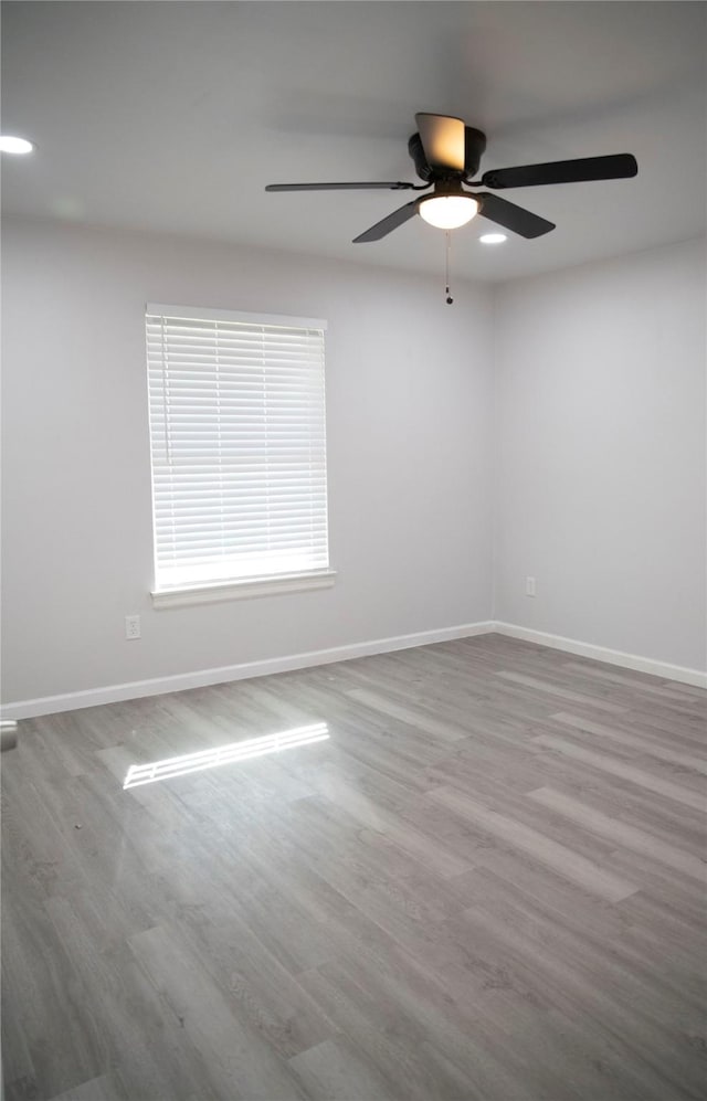 empty room with ceiling fan and wood-type flooring