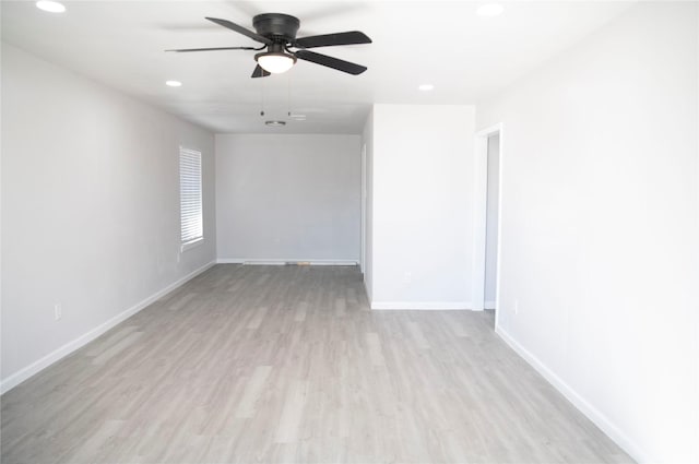 spare room featuring light hardwood / wood-style flooring and ceiling fan