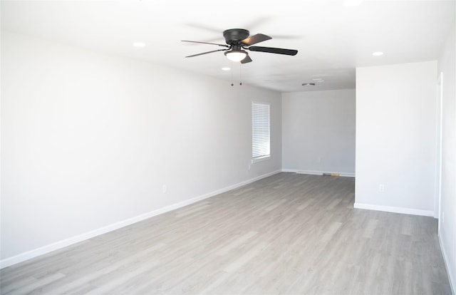 empty room featuring ceiling fan and light hardwood / wood-style flooring